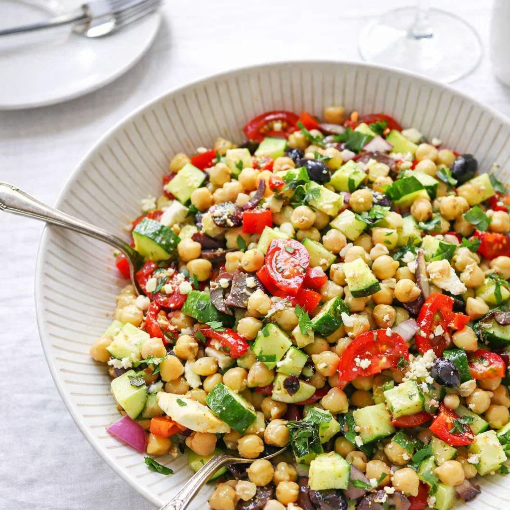 10-Minute Mediterranean Chickpea Salad in a white bowl on a wooden table