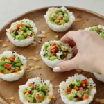 A platter of colorful Sushi Cups with spicy mayo and sesame seeds.