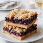Golden brown Blackberry Crumb Bars with juicy berry filling.