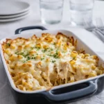 Golden bubbly chicken alfredo casserole in a white baking dish