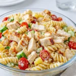 A vibrant bowl of Chicken Club Pasta Salad with bacon and avocado.