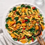 A vibrant bowl of Asian Pasta Salad with mandarin oranges and almonds.