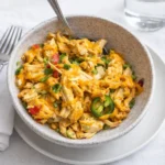 A bubbling Jalapeño Buffalo Chicken Casserole topped with fresh jalapeños