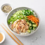 A colorful Spicy Crab Poke Bowl with avocado and carrots.