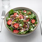 Fresh Spring Mix Salad with Balsamic Honey Dressing in a wooden bowl.