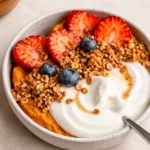 A delicious Sweet Potato Breakfast Bowl topped with fruit and almond butter.