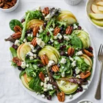 Apple Cranberry Salad With Maple Dijon Dressing in a white bowl on a wooden table