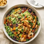 A vibrant Chicken Cashew Crunch Salad with grilled chicken and cashews.
