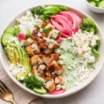 A vibrant Green Goddess Bowl with grilled chicken and avocado.