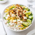 A vibrant Healthy Street Corn Chicken Rice Bowl with grilled chicken and lime.