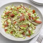High Protein Italian Grinder Salad in a wooden bowl on a marble counter