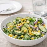 Mexican Cucumber Salad in a white bowl with lime and chili garnish.