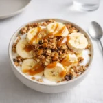 A delicious Salted Caramel Banana Yogurt Bowl with fresh bananas and granola.