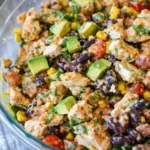 A bowl of Zesty Southwest Chicken Salad with corn and beans.